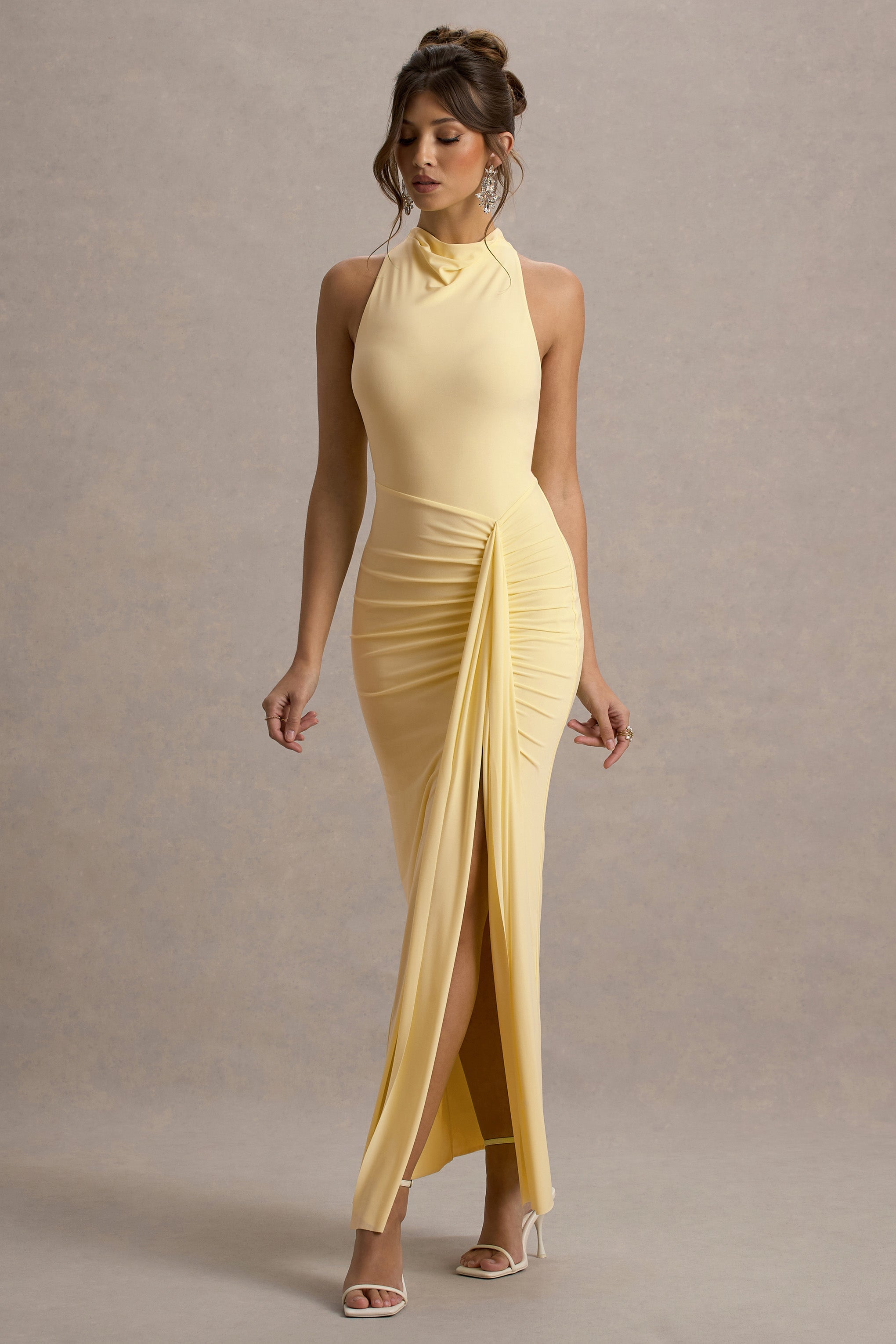 Front view of yellow halter neck maxi dress on model