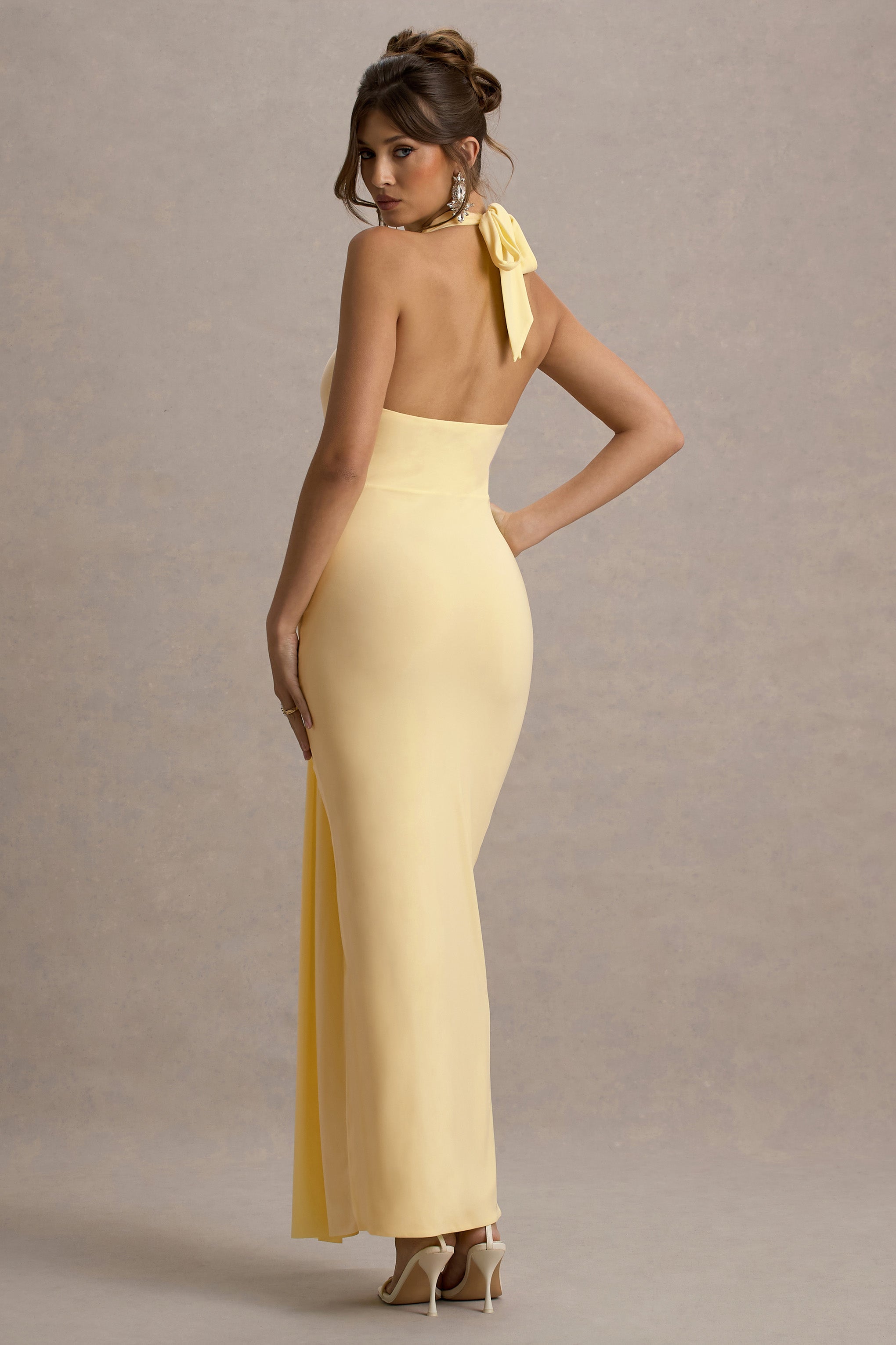 Back view of yellow halter neck ruched maxi dress with tie detail